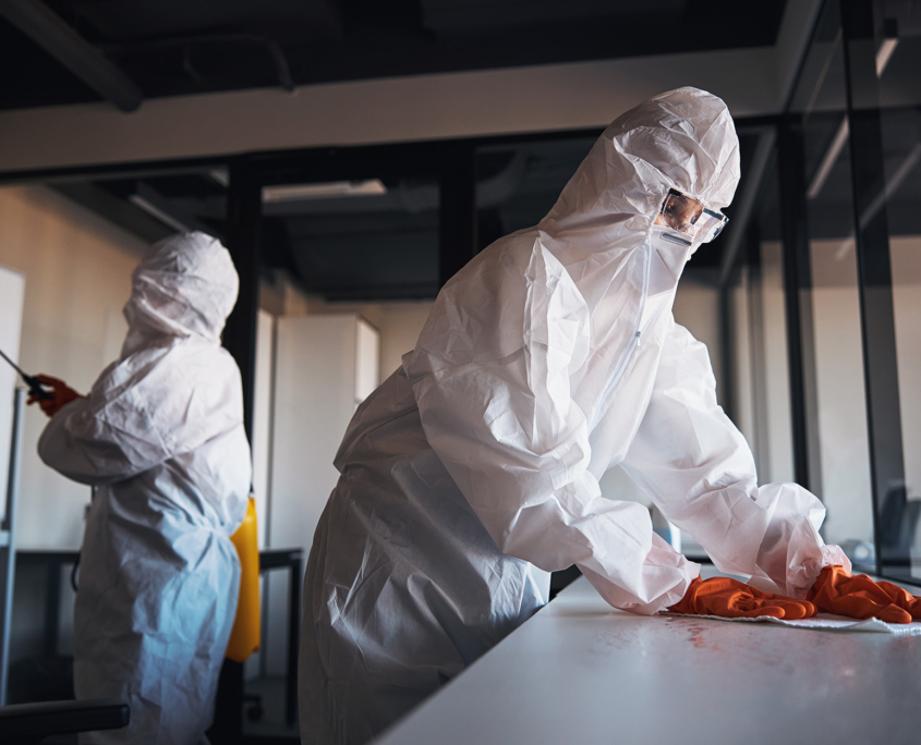 Side View, Two People In Protective Suits Cleaning Contaminated Office