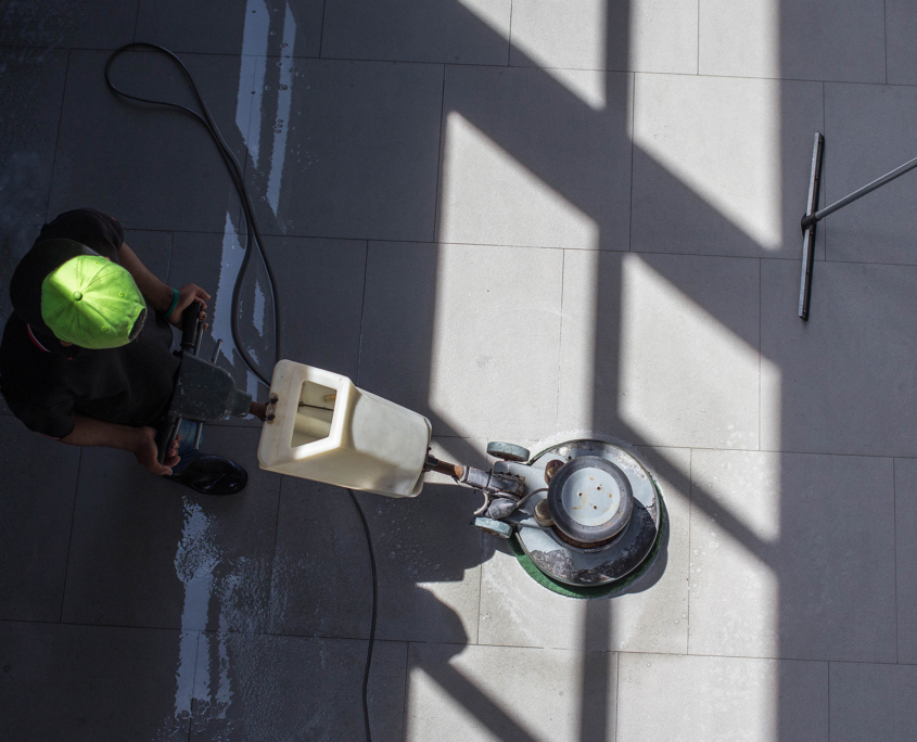 Top Down View, Man Using Industrial Machine To Clean Hard Floor