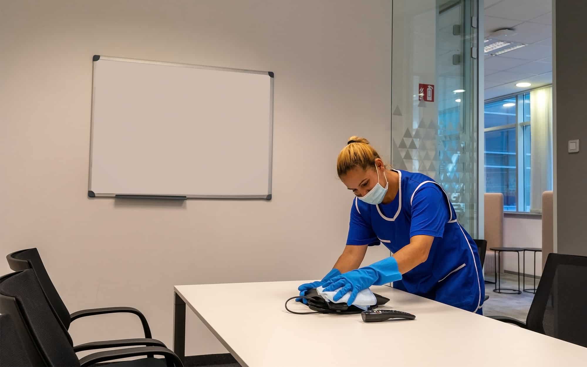 Mirrored, Side View Of A Female Janitor Cleaning Landline Phone